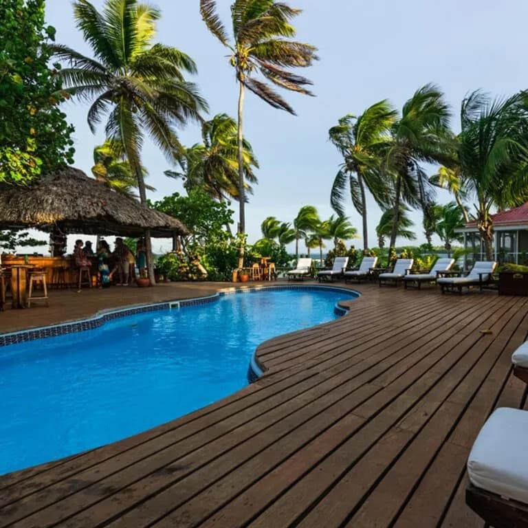 Swimming pool and deck at the Belize luxury dive resort Turneffe Island Resort
